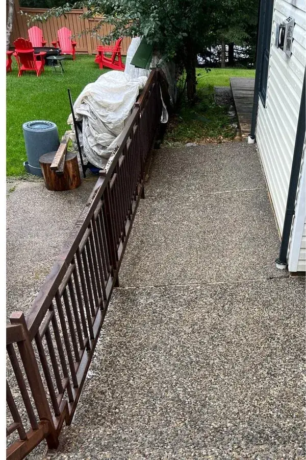 The same exposed-aggregate walkway clean after pressure washing.